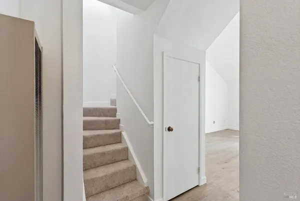 a view of staircase with white walls