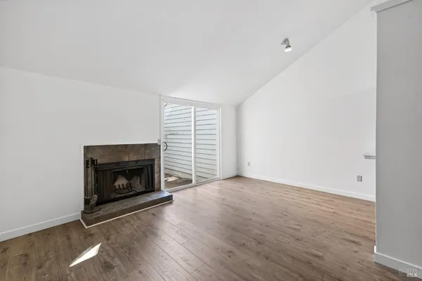 a view of empty room with a fireplace