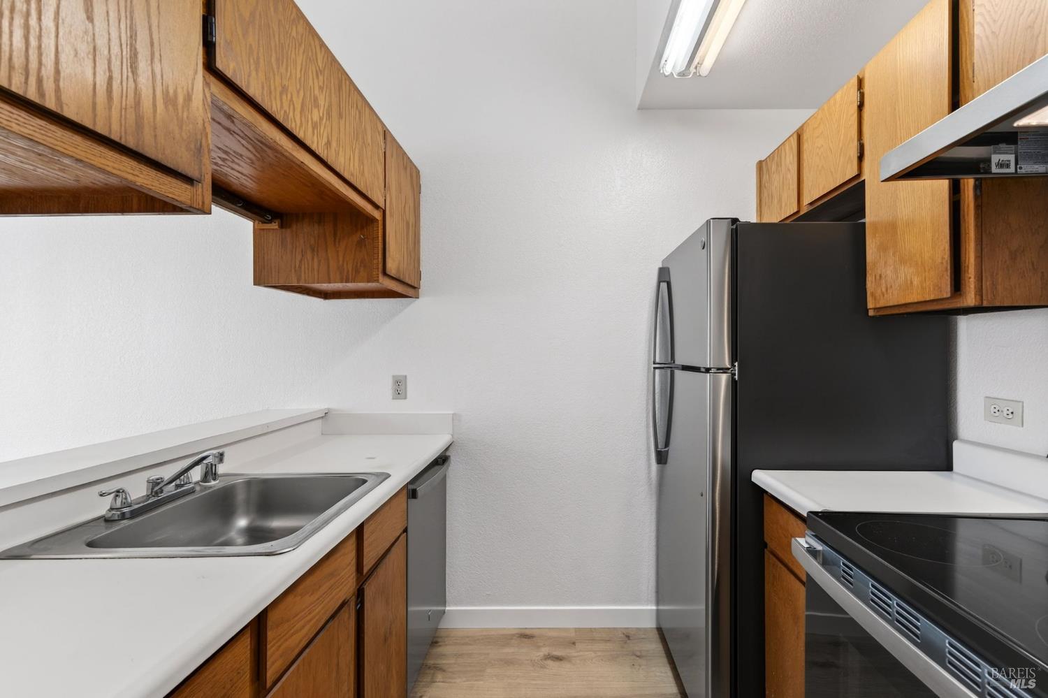 230 Courtyards East Windsor, CA 95492 - Photo 17 of 47 a kitchen with stainless steel appliances granite countertop a sink and a refrigerator