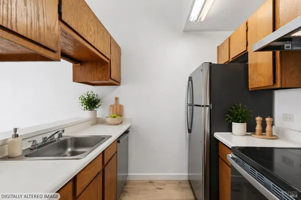 a kitchen with stainless steel appliances granite countertop a sink and a refrigerator