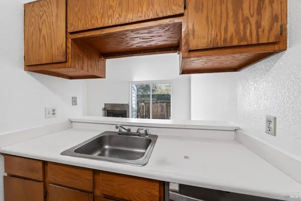 a kitchen with a sink cabinets and a window
