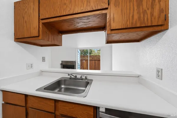 a kitchen with stainless steel appliances granite countertop a sink and a microwave