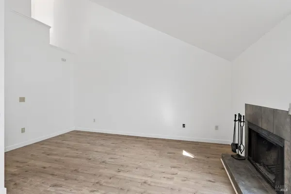 a view of empty room with fireplace