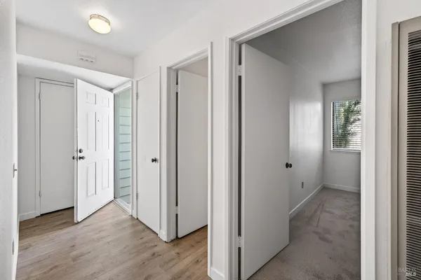 a view of a hallway with wooden floor