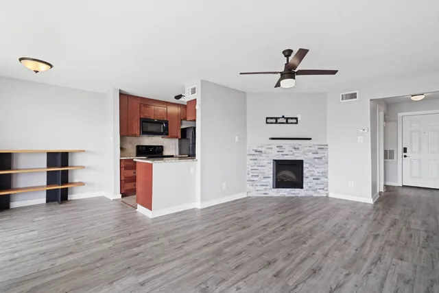 a kitchen with stainless steel appliances wooden cabinets and a stove top oven