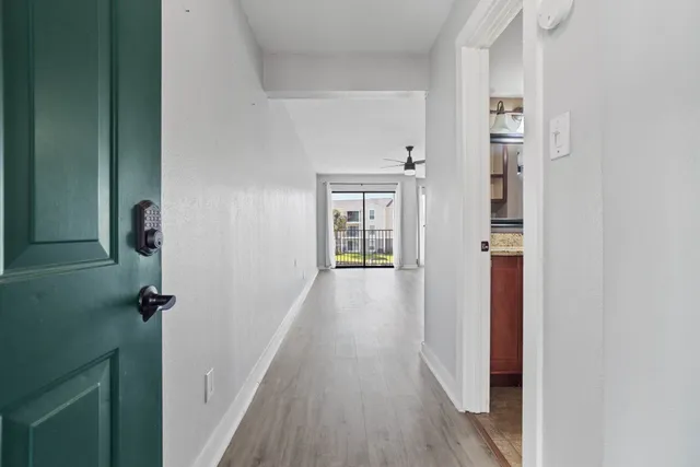 a view of an empty room with a fireplace and a window