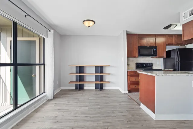 a kitchen with stainless steel appliances a refrigerator and a stove top oven