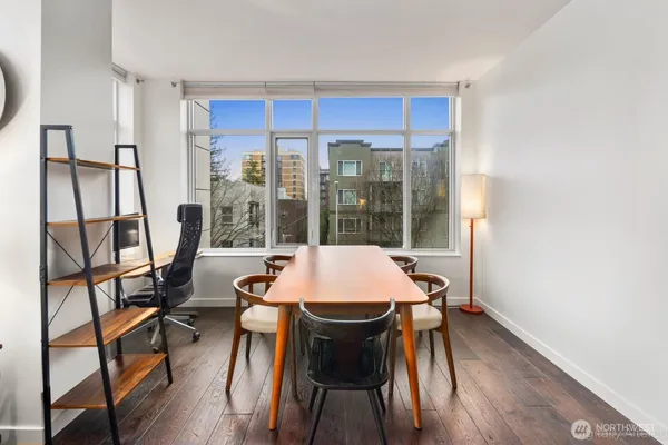 a view of a dining room with furniture window and wooden floor