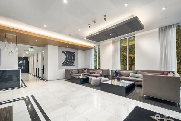 a large living room with stainless steel appliances kitchen island granite countertop a large window