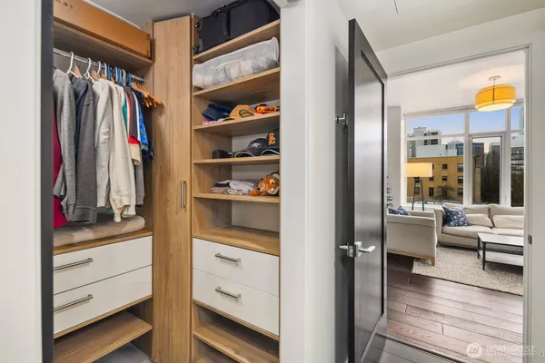a view of walk in closet with clothes and shoes