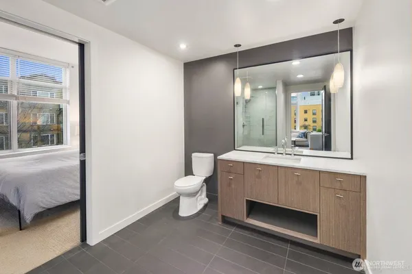 a bathroom with a sink a toilet and mirror