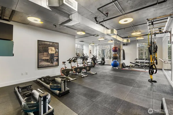 a room with gym equipment and a view of mirror