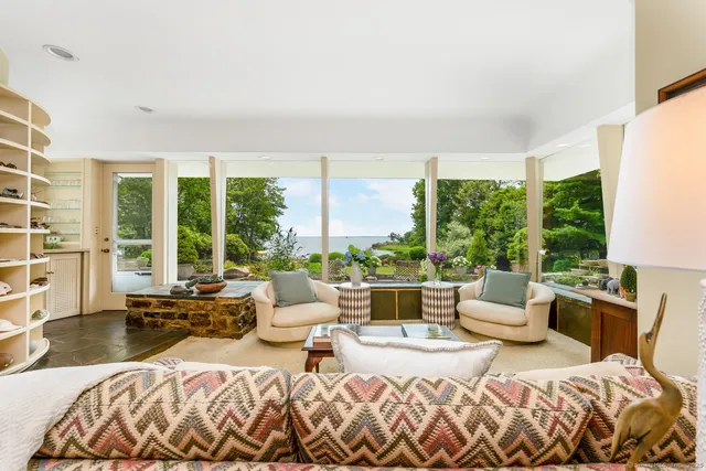 a bedroom with a bed and large windows