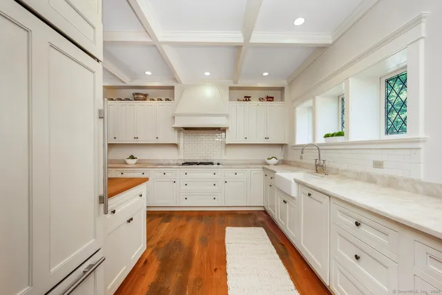 a large white kitchen with cabinets