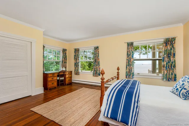 a living room with furniture fireplace and wooden floor