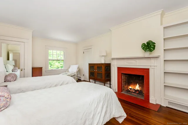 a bedroom with a bed and a fireplace