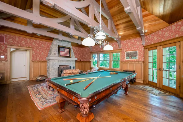 a room with pool table and windows