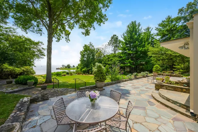a view of a backyard with sitting area
