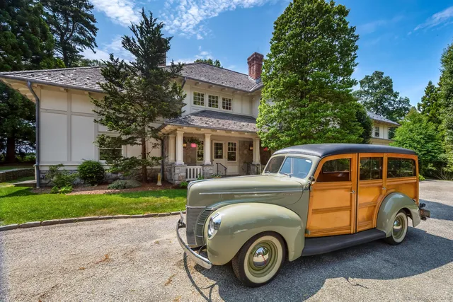 a front view of a house with a garden and parking space