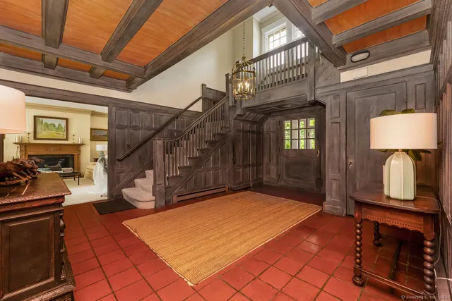 a view of an entryway with wooden floor and a livingroom view