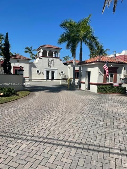 6705 North Kendall Drive, Unit 305 Pinecrest, FL 33156 - Photo 5 of 11 a front view of a house with a yard and garage