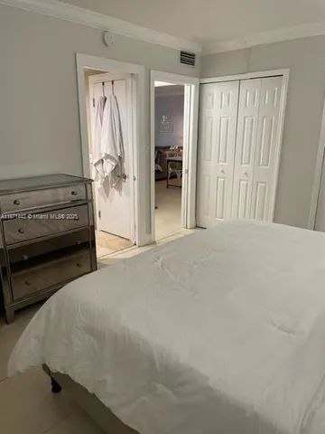 a bedroom with a bed and a cabinets