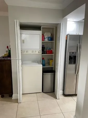 a view of kitchen with furniture and refrigerator