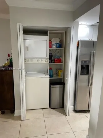 a view of kitchen with furniture and refrigerator