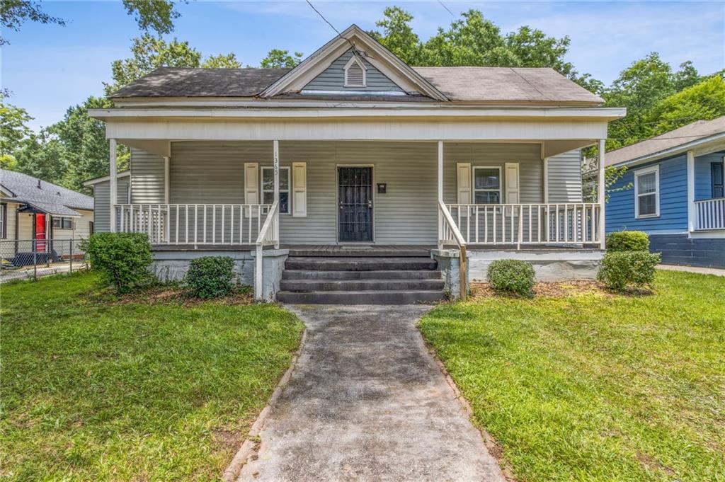 1365 Athens Avenue Southwest Atlanta, GA 30310 - Photo 1 of 1 a front view of a house with garden
