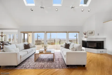 a living room with fireplace furniture and a rug