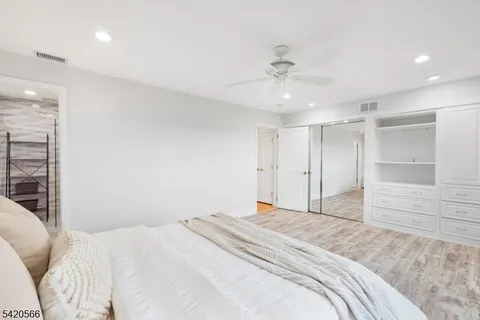 a bedroom with a large bed cabinets and bedroom