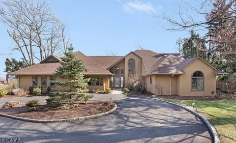 a front view of a house with a yard and a garden