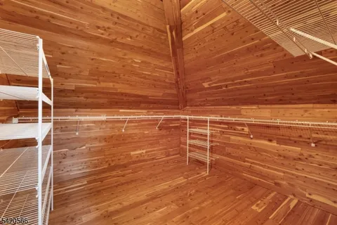 a view of a room with wooden floor and white walls
