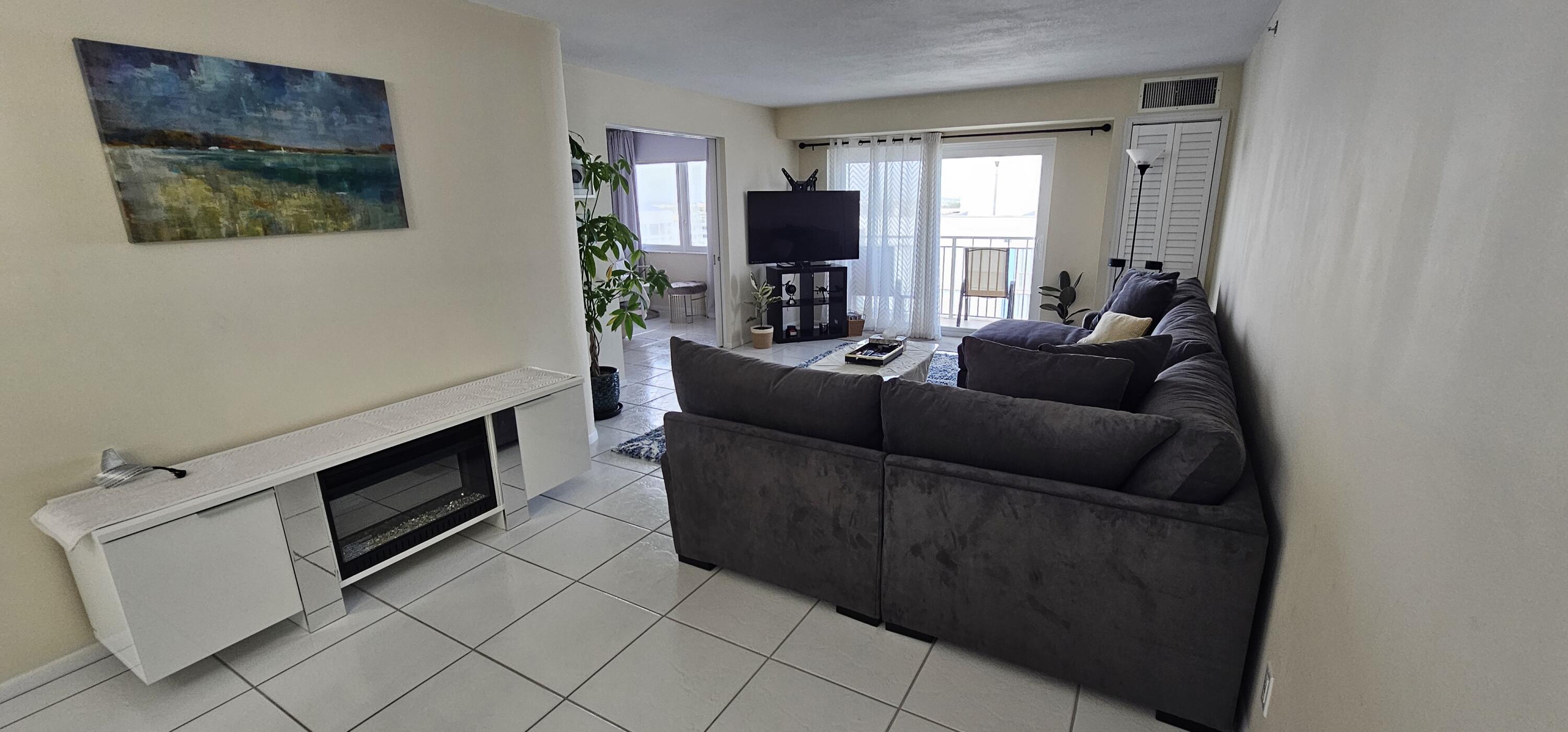 3215 South Ocean Boulevard, Unit 1010 Highland Beach, FL 33487 - Photo 3 of 23 a living room with furniture and a flat screen tv
