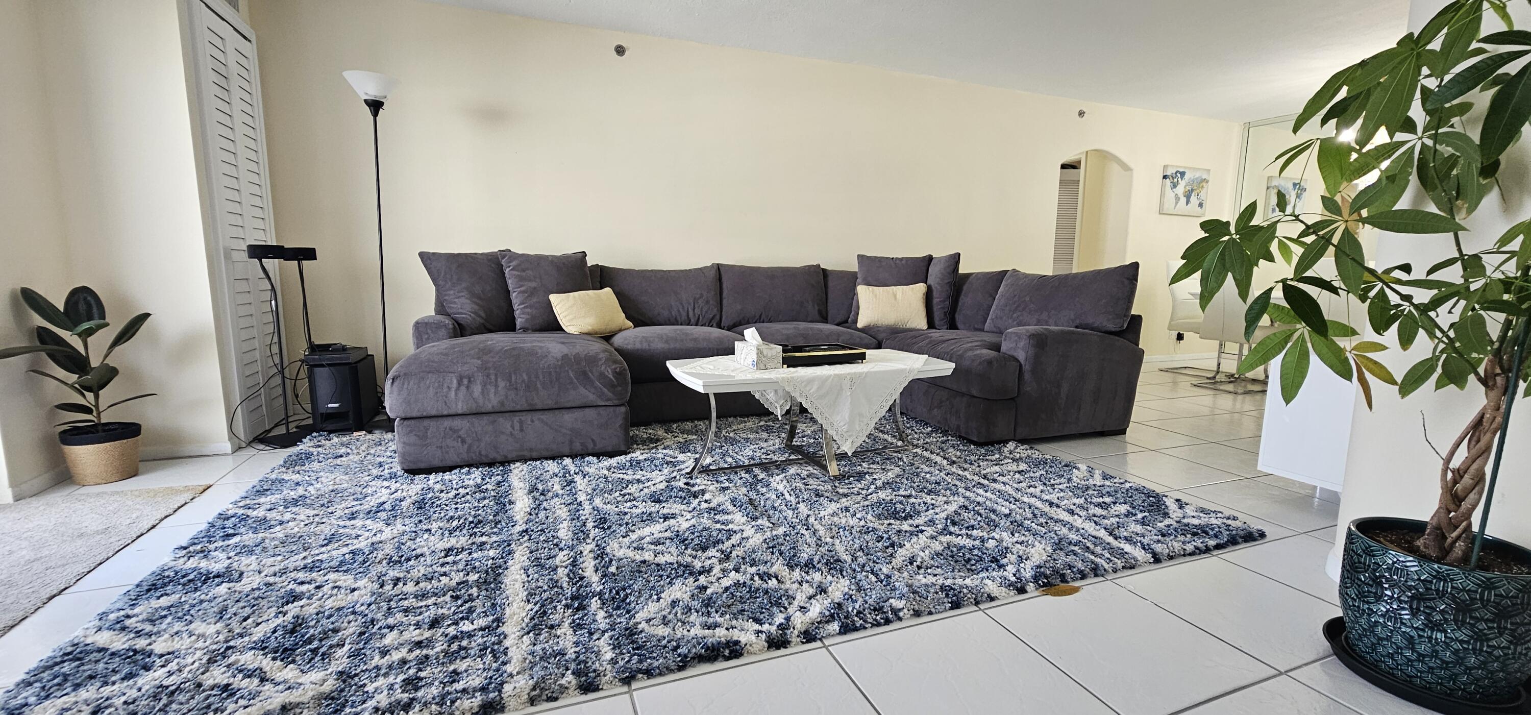 3215 South Ocean Boulevard, Unit 1010 Highland Beach, FL 33487 - Photo 4 of 23 a living room with furniture and a potted plant