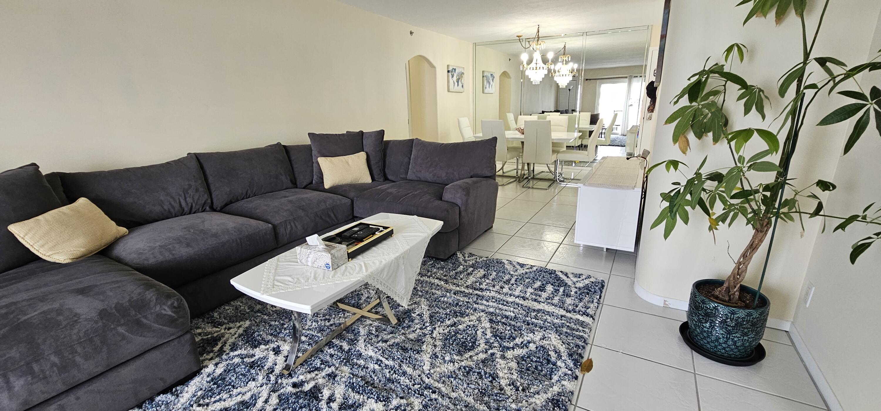 3215 South Ocean Boulevard, Unit 1010 Highland Beach, FL 33487 - Photo 5 of 23 a living room with furniture and a potted plant