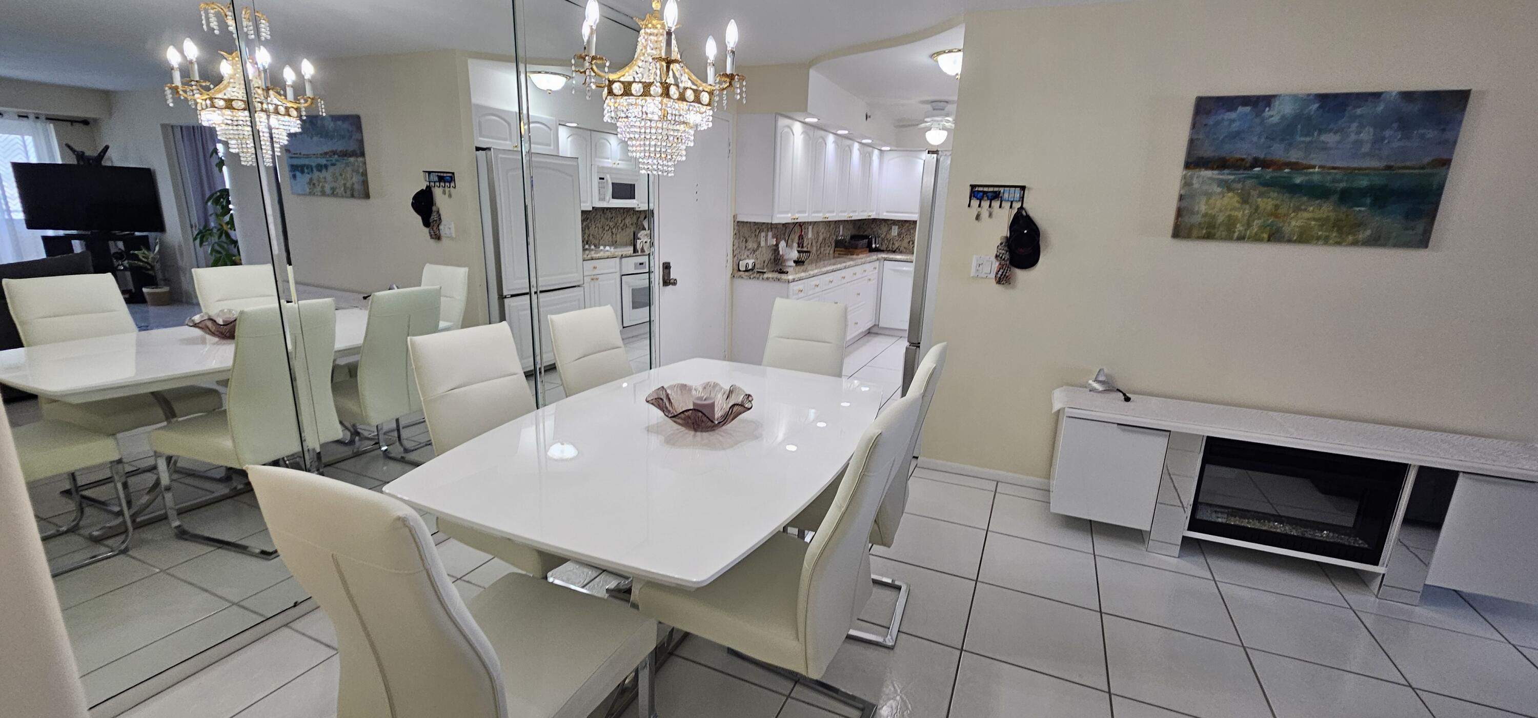 3215 South Ocean Boulevard, Unit 1010 Highland Beach, FL 33487 - Photo 7 of 23 a view of a dining room with furniture and chandelier
