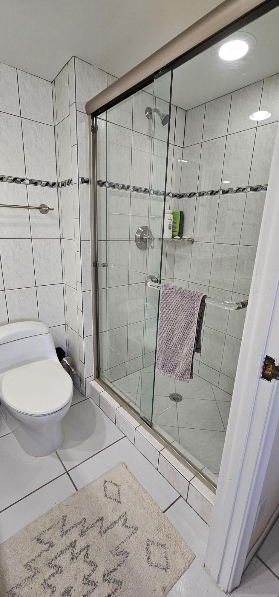 3215 South Ocean Boulevard, Unit 1010 Highland Beach, FL 33487 - Photo 10 of 23 a bathroom with a toilet and a shower