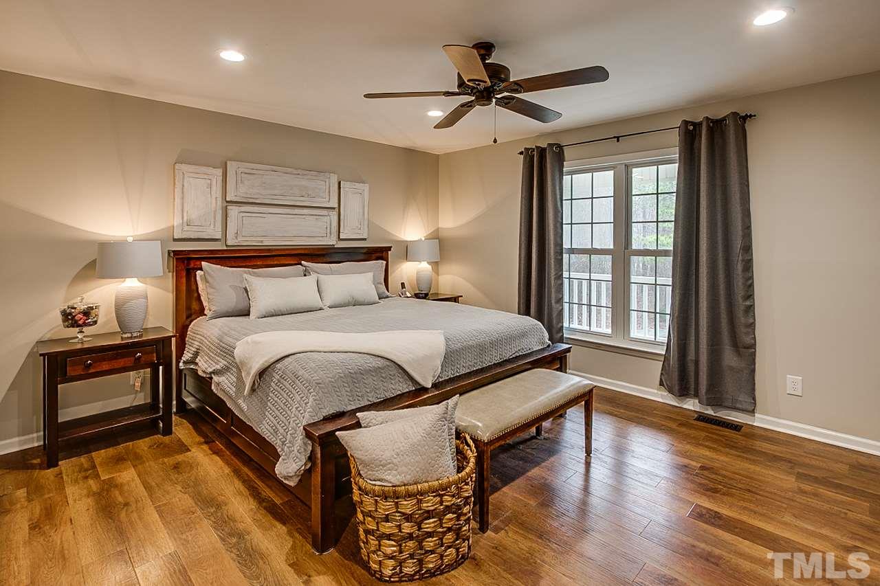 306 Charlie S Road Robbins, NC 27325 - Photo 13 of 30 a bedroom with a bed and wooden floor