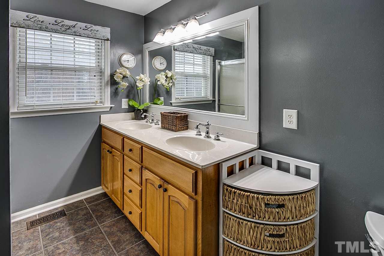 306 Charlie S Road Robbins, NC 27325 - Photo 14 of 30 a bathroom with a sink double vanity and a two mirror