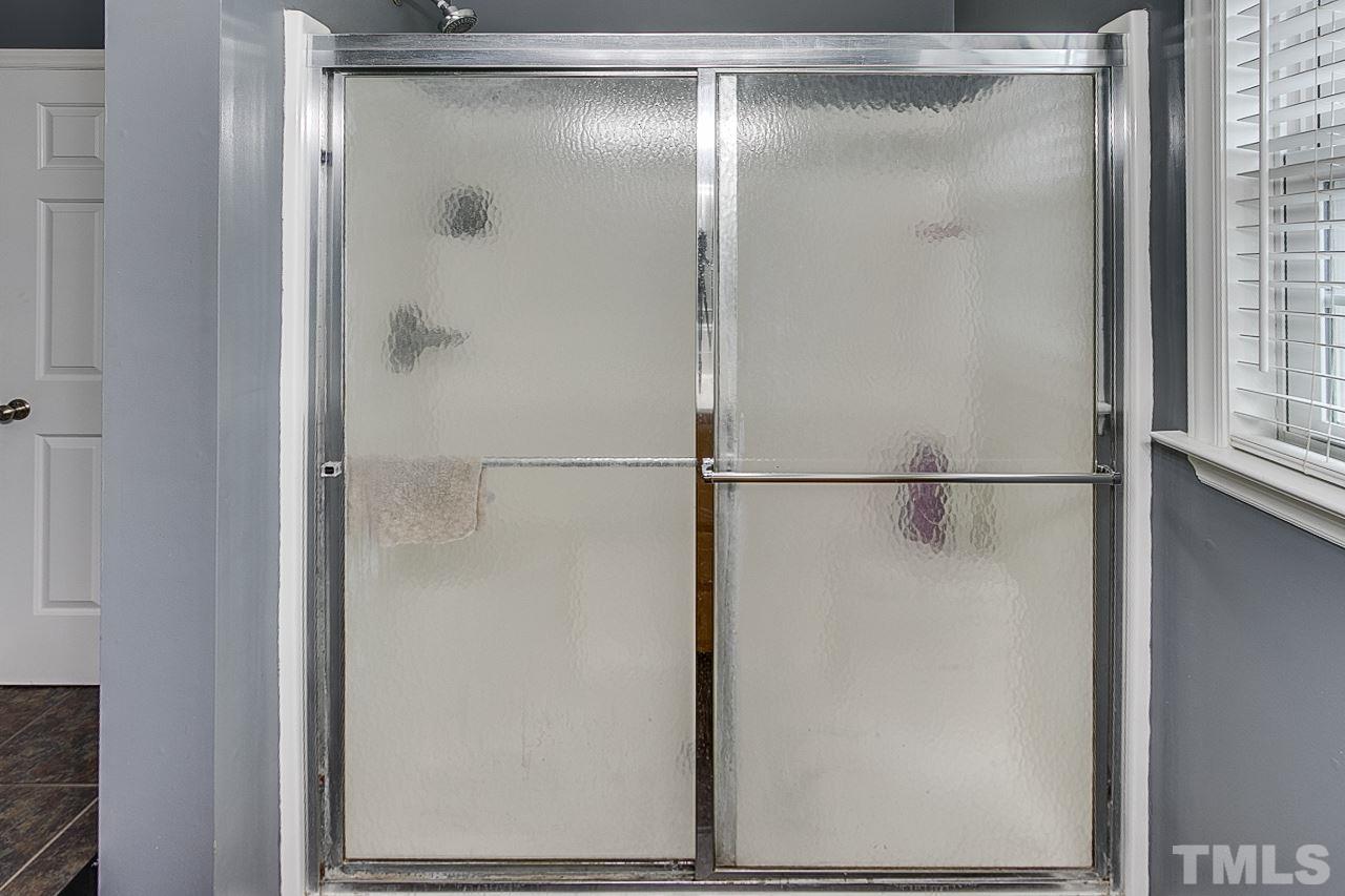 306 Charlie S Road Robbins, NC 27325 - Photo 15 of 30 a bathroom with a glass shower door
