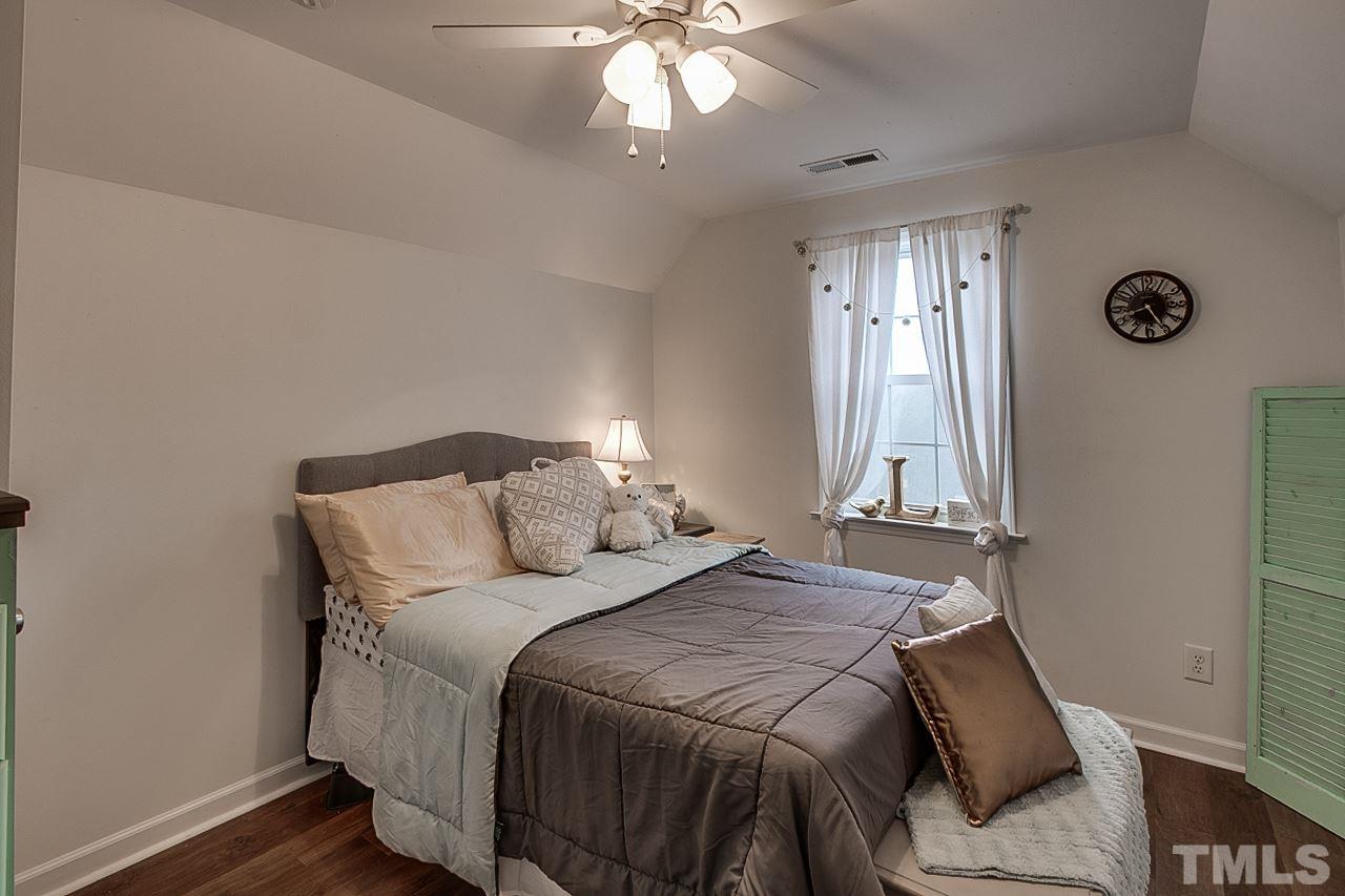 306 Charlie S Road Robbins, NC 27325 - Photo 19 of 30 a bedroom with a bed and a chandelier