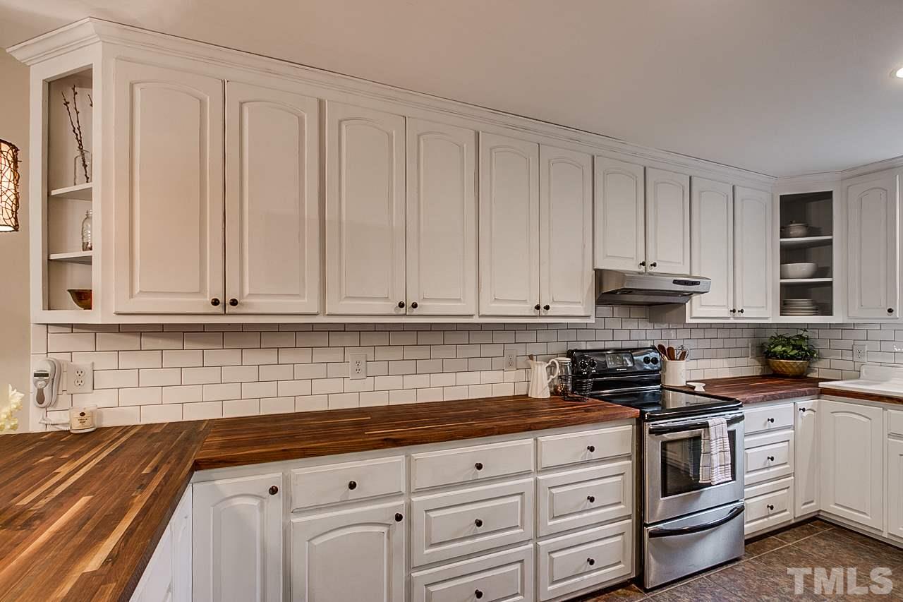 306 Charlie S Road Robbins, NC 27325 - Photo 7 of 30 a kitchen with granite countertop white cabinets and stainless steel appliances