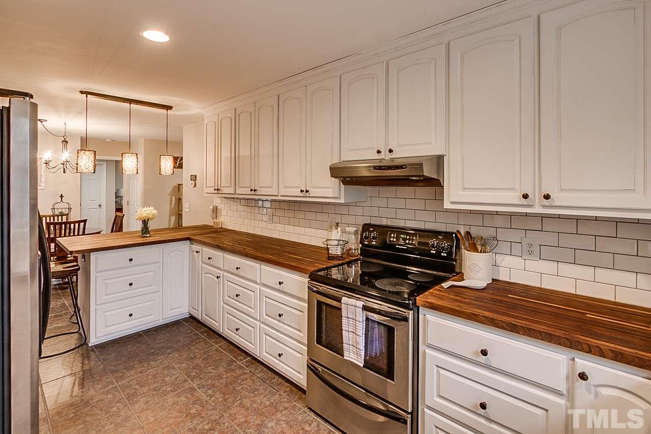 306 Charlie S Road Robbins, NC 27325 - Photo 8 of 30 a kitchen with granite countertop white cabinets and stainless steel appliances