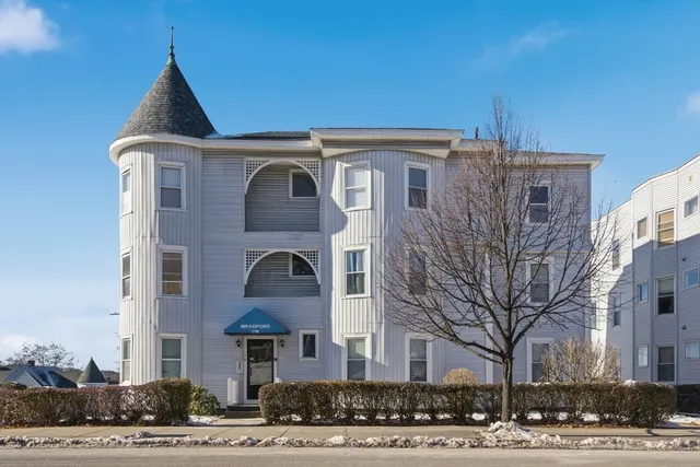 a front view of a residential apartment building with a yard