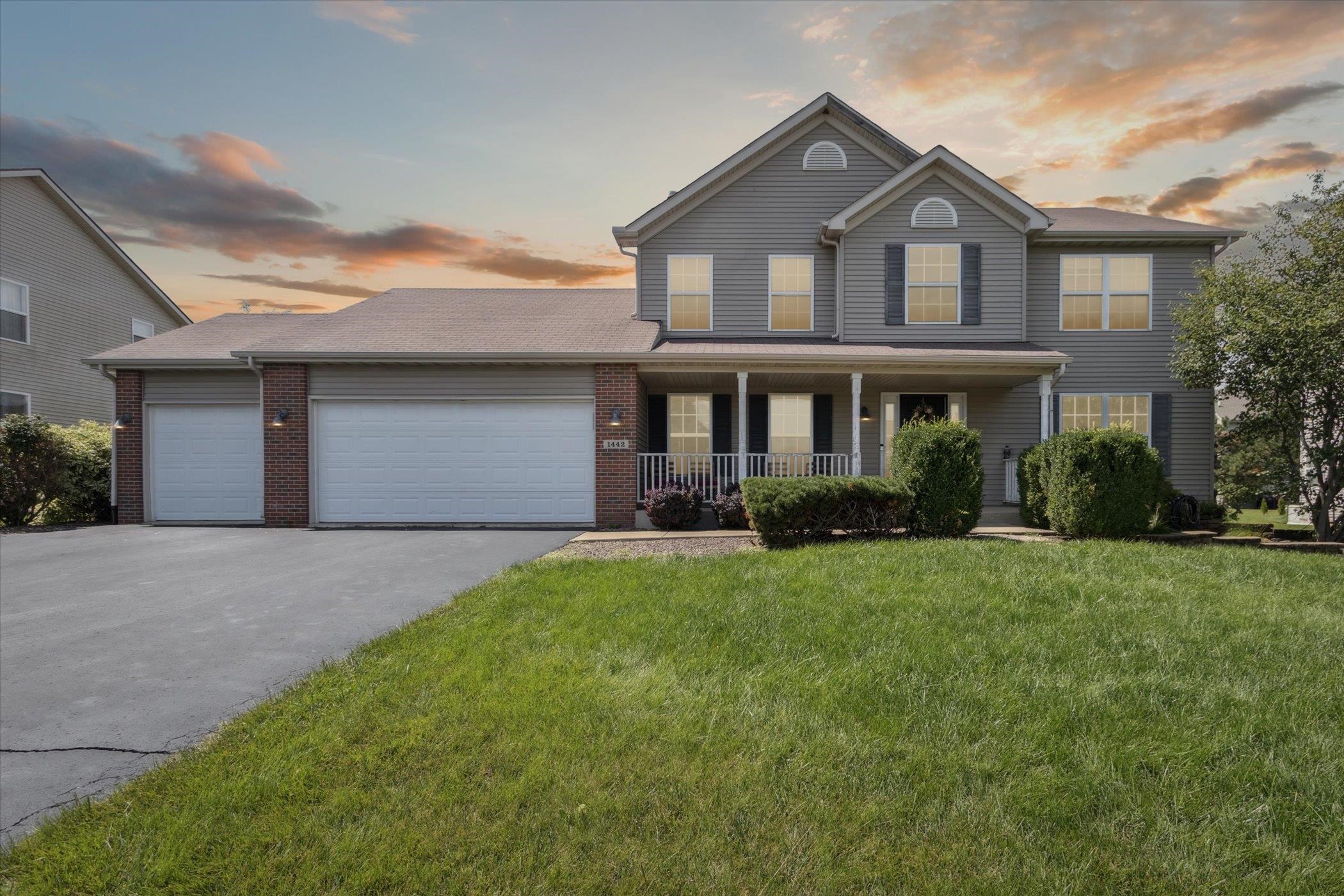 1442 Rock Island Road Davis Junction, IL 61020 - Photo 1 of 63 a front view of a house with a yard and garage