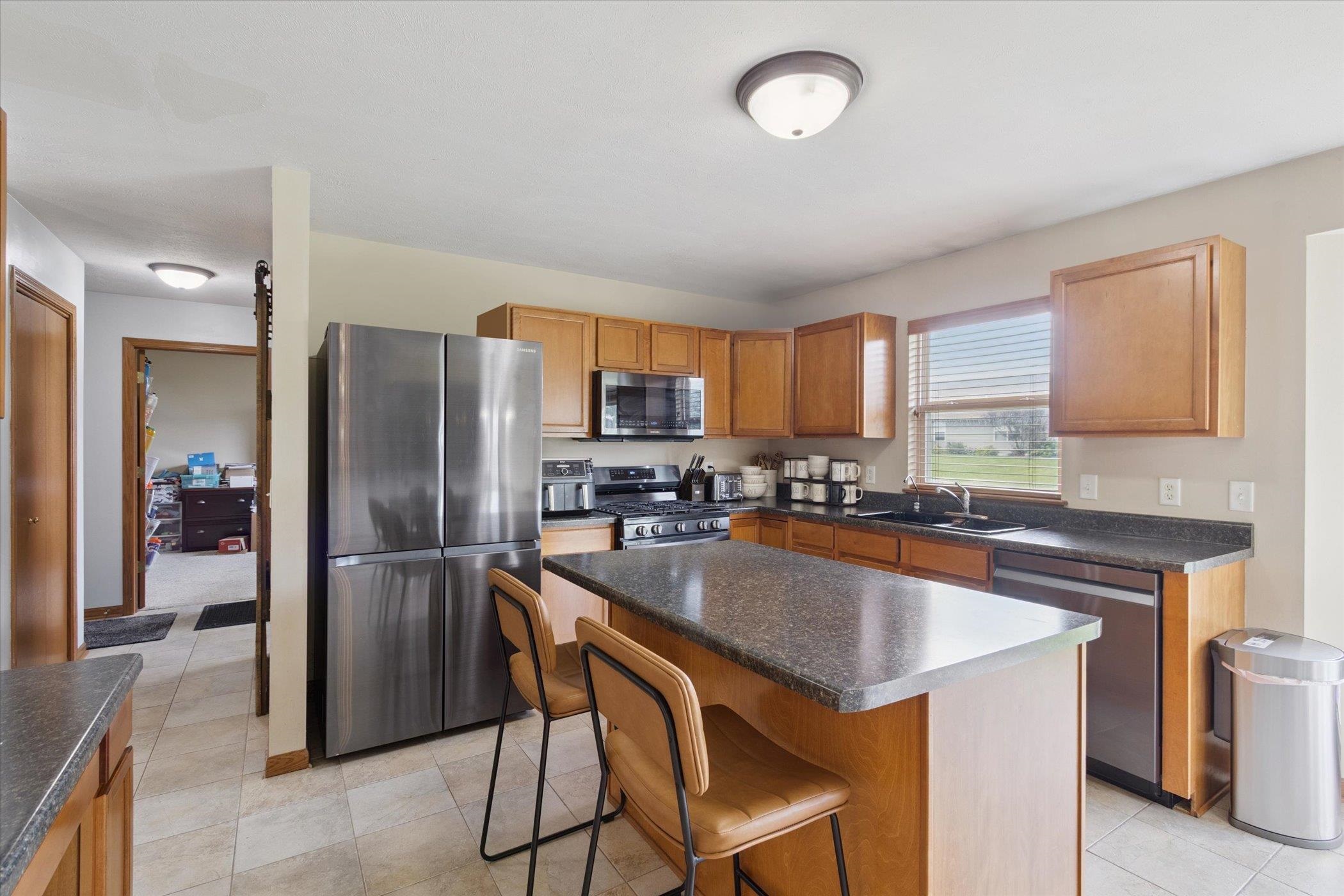 1442 Rock Island Road Davis Junction, IL 61020 - Photo 19 of 63 a kitchen with stainless steel appliances granite countertop a refrigerator a stove a sink and a refrigerator