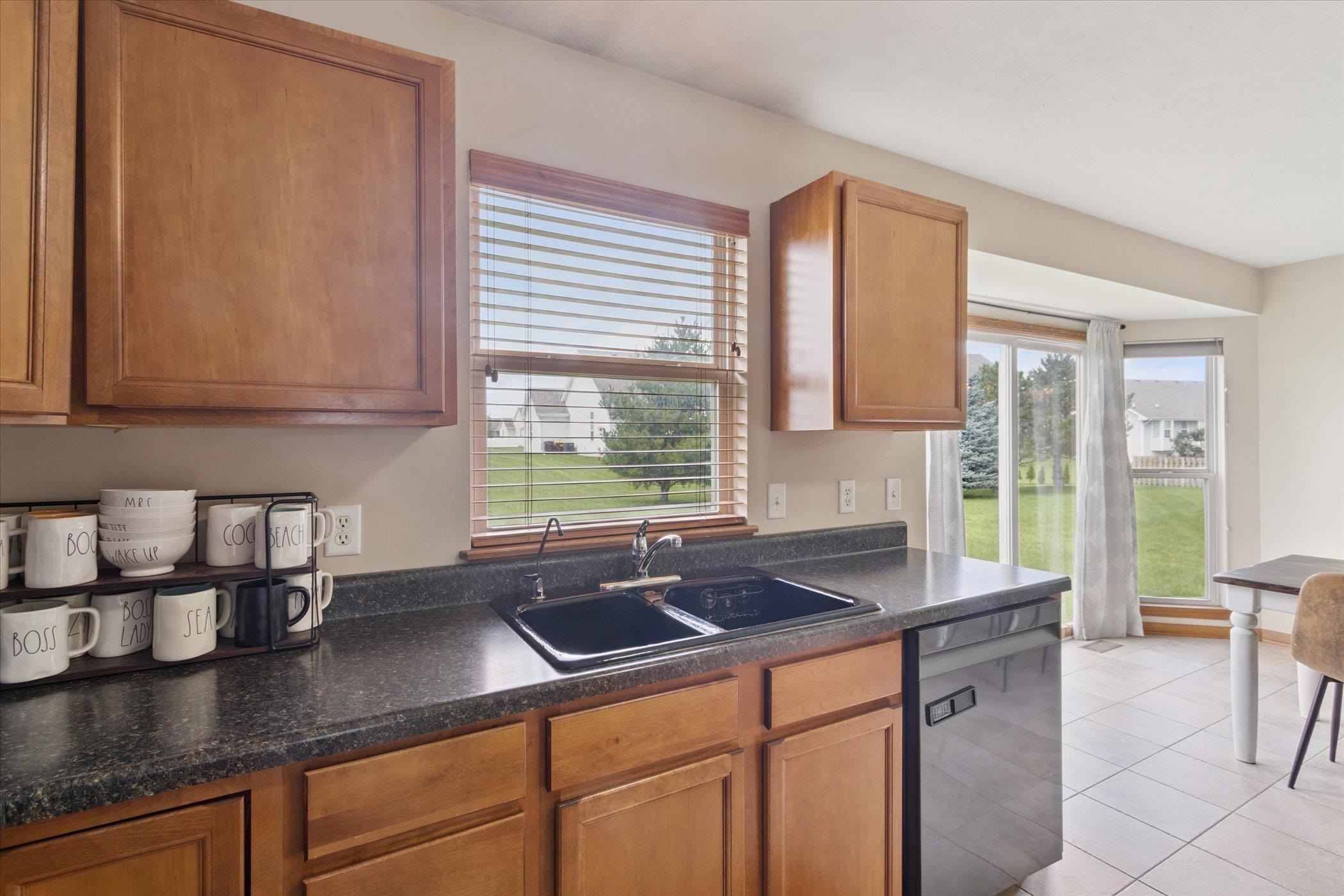 1442 Rock Island Road Davis Junction, IL 61020 - Photo 22 of 63 a kitchen with stainless steel appliances granite countertop a sink a refrigerator and cabinets