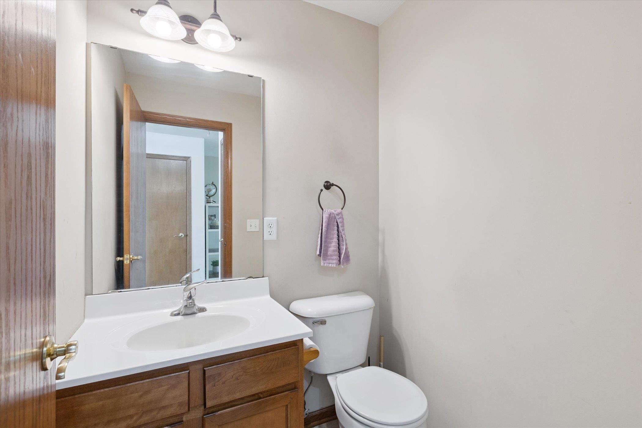 1442 Rock Island Road Davis Junction, IL 61020 - Photo 25 of 63 a bathroom with a sink vanity mirror and toilet