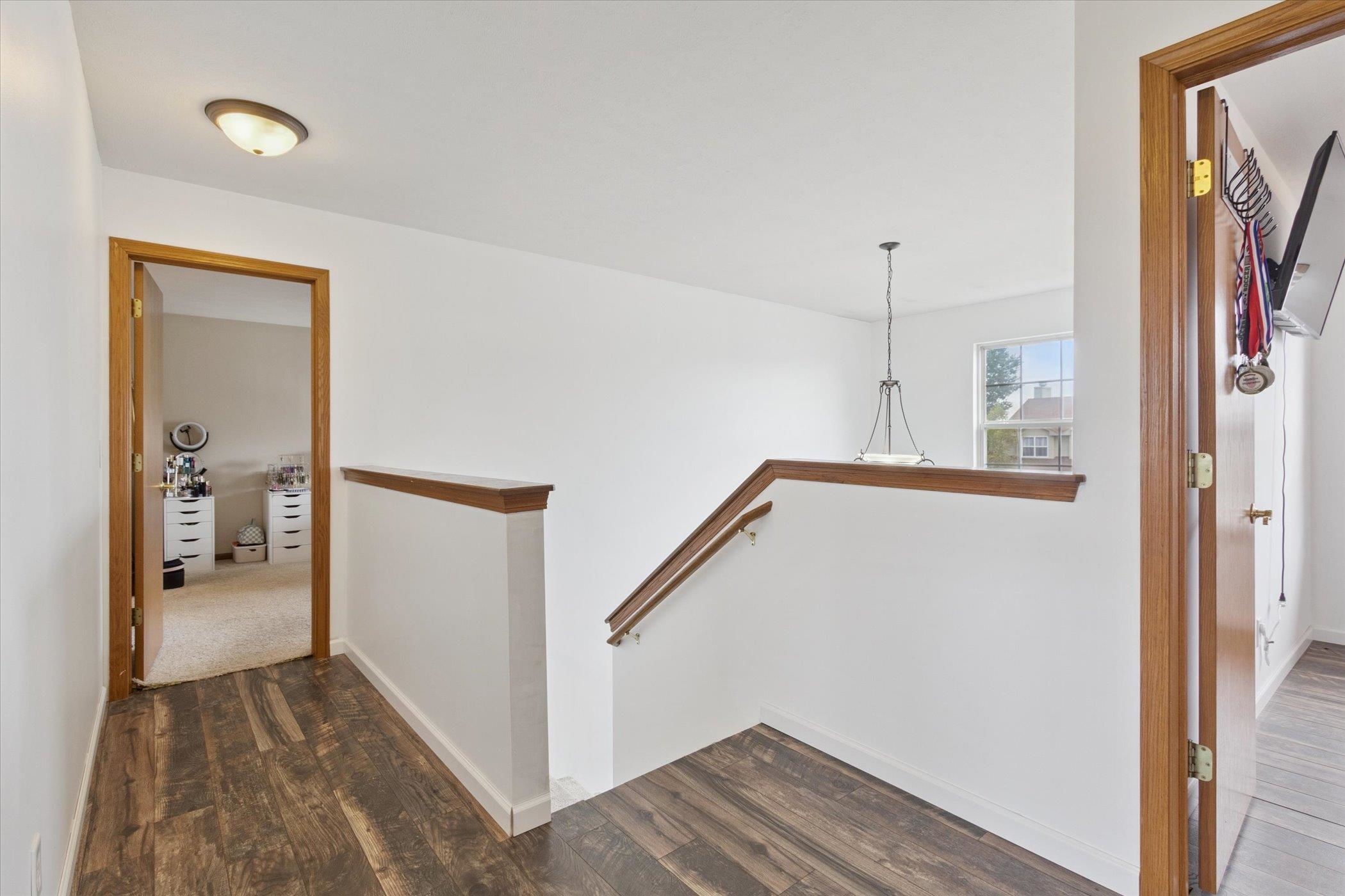 1442 Rock Island Road Davis Junction, IL 61020 - Photo 29 of 63 a view of a hallway with wooden floor and a living room